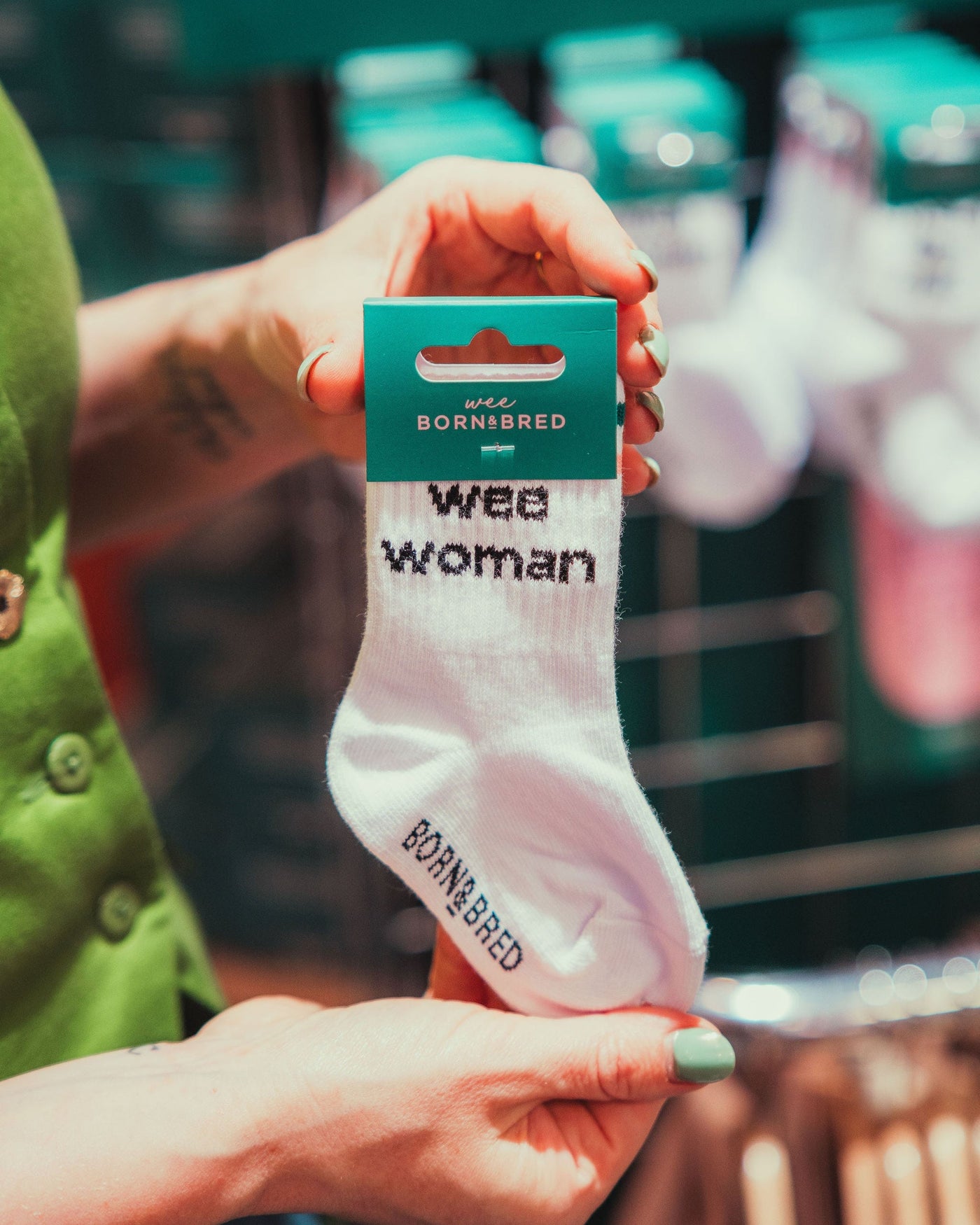 person holding white wee woman socks