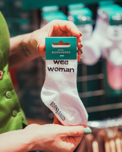 person holding white wee woman socks