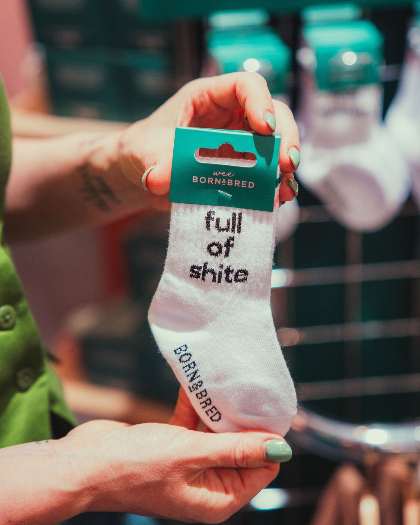 person holding kids full of shite baby socks